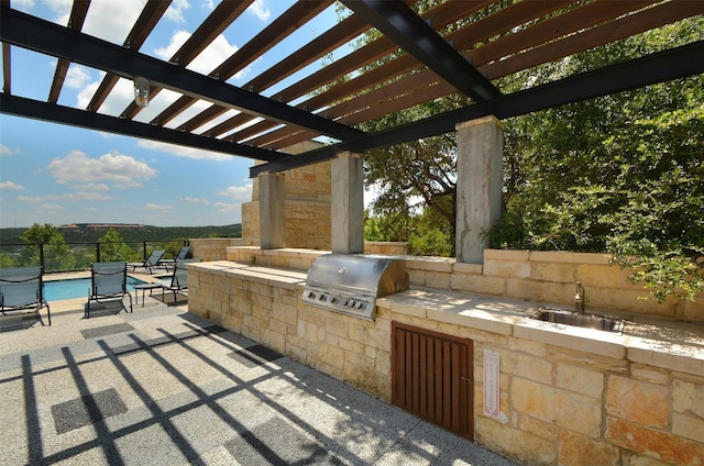 view of patio featuring a pergola, a sink, an outdoor kitchen, a fenced in pool, and area for grilling