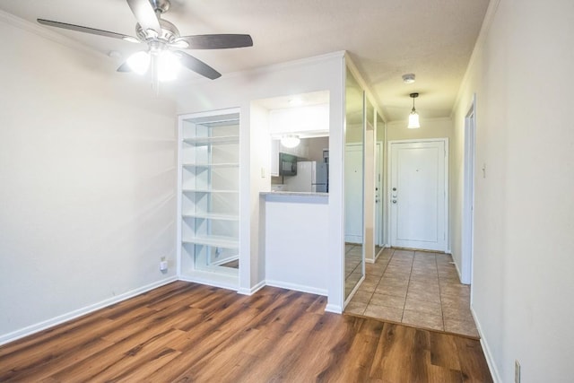 7920 Rockwood Ln Unit 202, Austin, TX 78757 - spare room with ornamental molding, wood finished floors, a ceiling fan, and baseboards