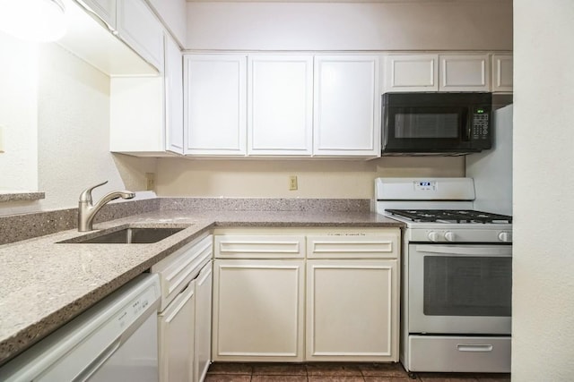 7920 Rockwood Ln Unit 202, Austin, TX 78757 - kitchen featuring white appliances, a sink, white cabinets, and light stone counters