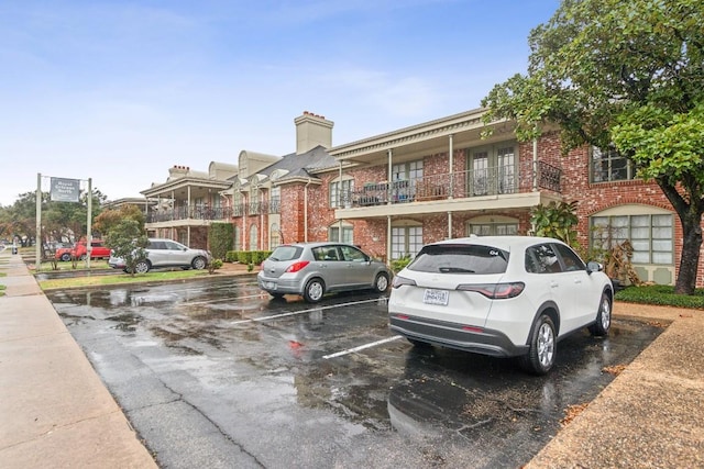 7920 Rockwood Ln Unit 202, Austin, TX 78757 - view of front of home featuring brick siding, uncovered parking, and a chimney