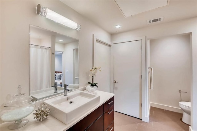 bathroom featuring tile patterned floors, vanity, and toilet