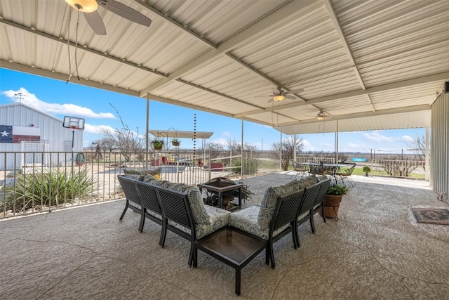 view of patio / terrace with outdoor dining area, a fire pit, fence, and ceiling fan