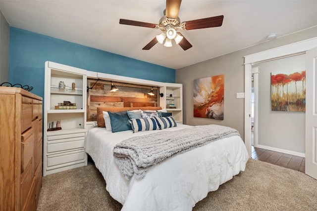 bedroom featuring dark colored carpet and ceiling fan