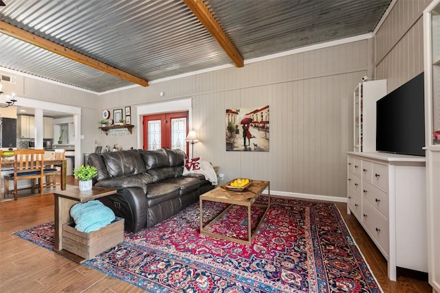 living room with visible vents, baseboards, and wood finished floors