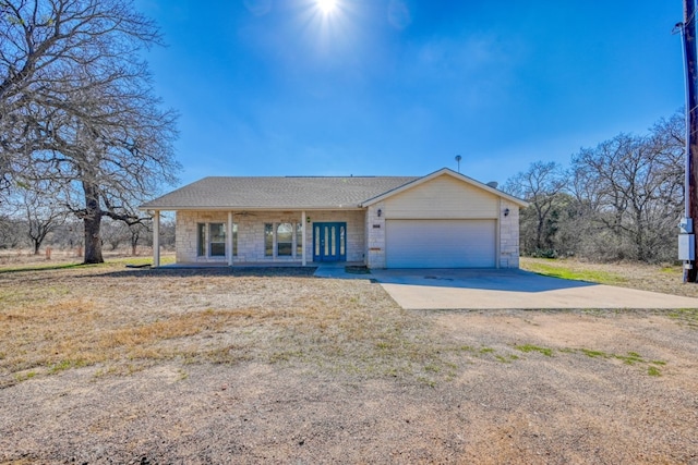 1504 Timber Valley Ln, Granite Shoals, TX 78654 - ranch-style house with driveway, a garage, covered porch, and stone siding