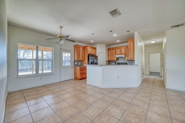 1504 Timber Valley Ln, Granite Shoals, TX 78654 - kitchen with stainless steel refrigerator with ice dispenser, under cabinet range hood, light countertops, recessed lighting, and a peninsula