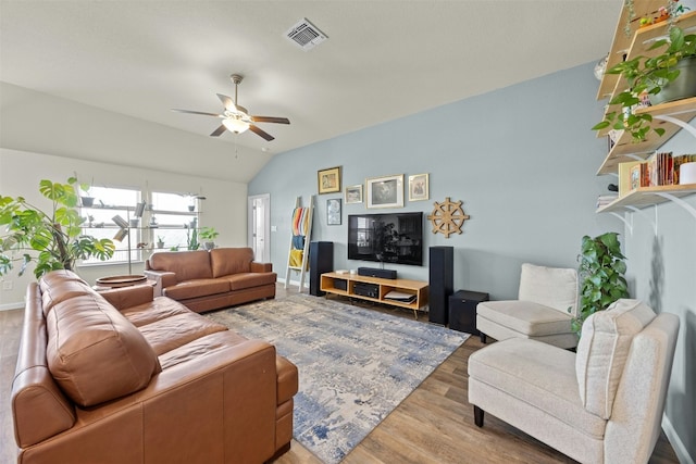 living room featuring lofted ceiling, wood-type flooring, and ceiling fan