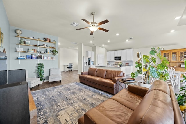 living room featuring hardwood / wood-style floors and ceiling fan