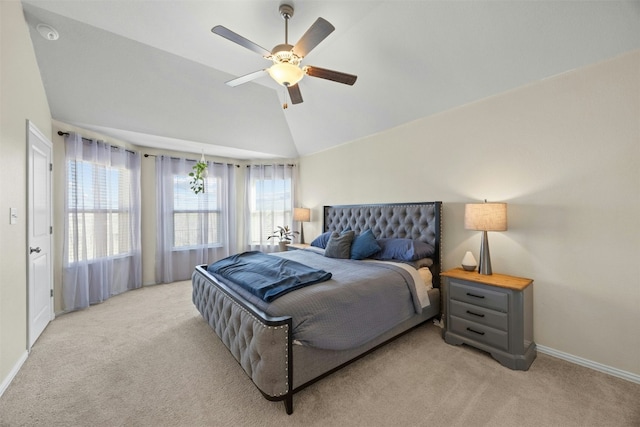 carpeted bedroom with vaulted ceiling and ceiling fan