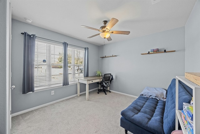 office space featuring ceiling fan and light carpet