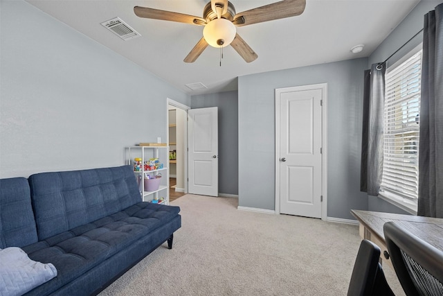 sitting room featuring light carpet and ceiling fan