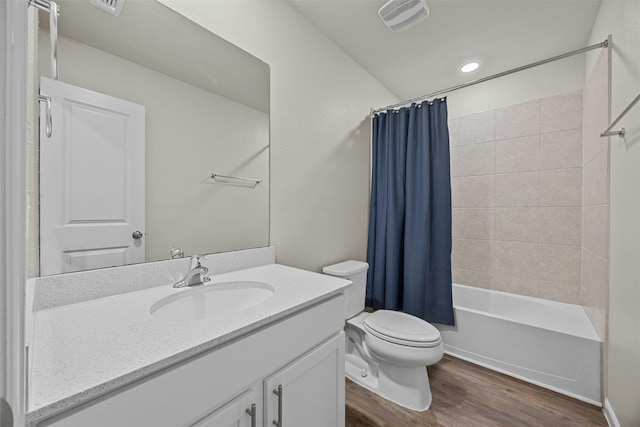 full bathroom with toilet, vanity, shower / bathtub combination with curtain, and hardwood / wood-style floors