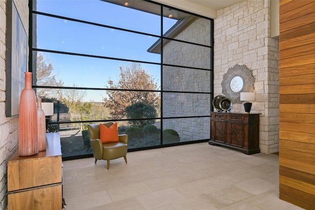 sitting room with a wall of windows and a high ceiling