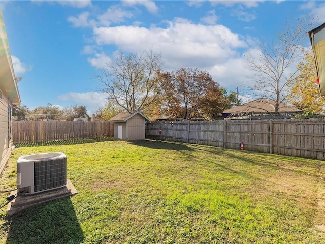 view of yard featuring central AC unit and a storage unit