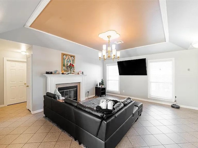 living room with lofted ceiling, a chandelier, a raised ceiling, and light tile patterned floors