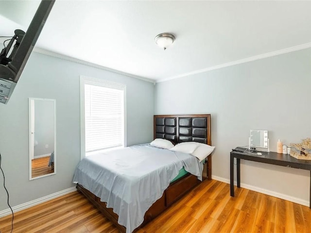 bedroom featuring hardwood / wood-style flooring and ornamental molding