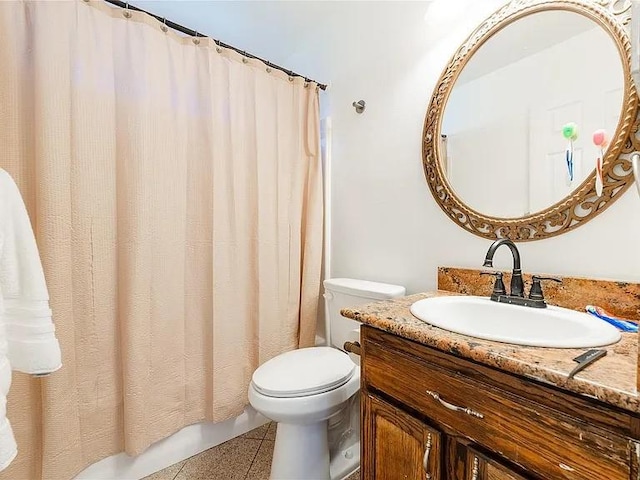 bathroom featuring tile patterned flooring, vanity, and toilet