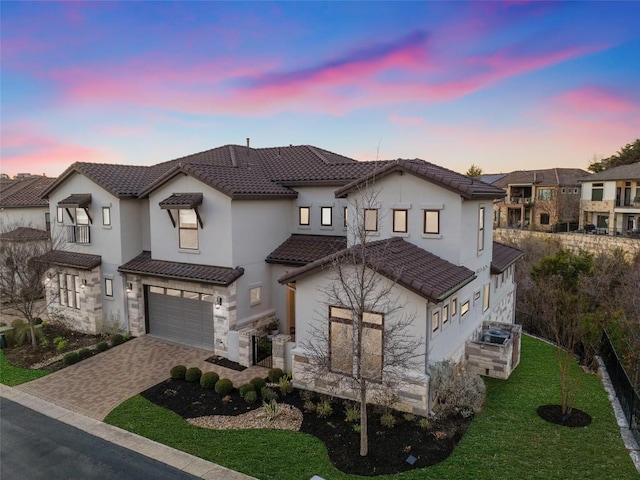 view of front of home featuring a garage and a yard