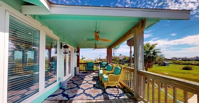 balcony featuring ceiling fan and a porch