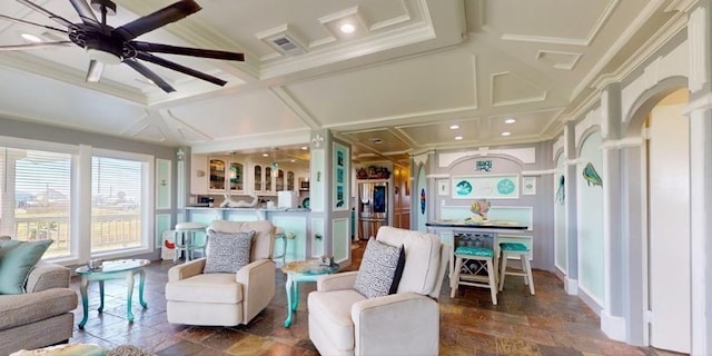 interior space with decorative columns, coffered ceiling, and ceiling fan