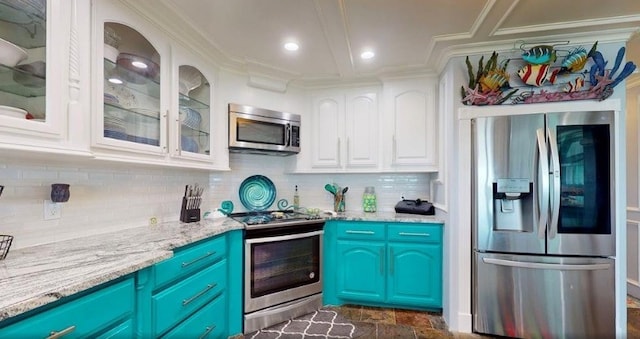 kitchen featuring backsplash, white cabinets, light stone counters, stainless steel appliances, and blue cabinetry