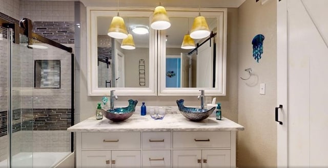 bathroom featuring vanity and combined bath / shower with glass door