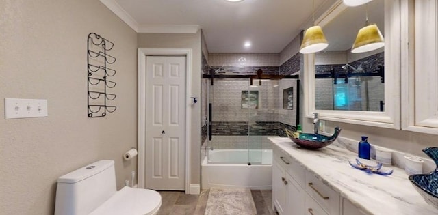 full bathroom featuring toilet, shower / bath combination with glass door, ornamental molding, vanity, and hardwood / wood-style flooring