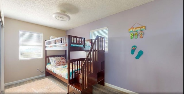 bedroom with hardwood / wood-style flooring and a textured ceiling