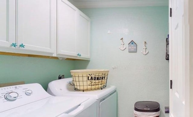 washroom featuring cabinets and independent washer and dryer