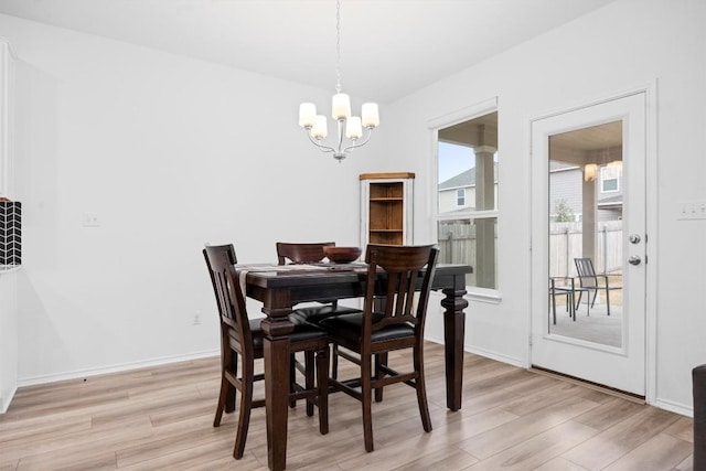 dining space featuring an inviting chandelier and light wood-type flooring