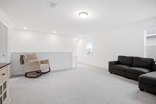 living area featuring light carpet