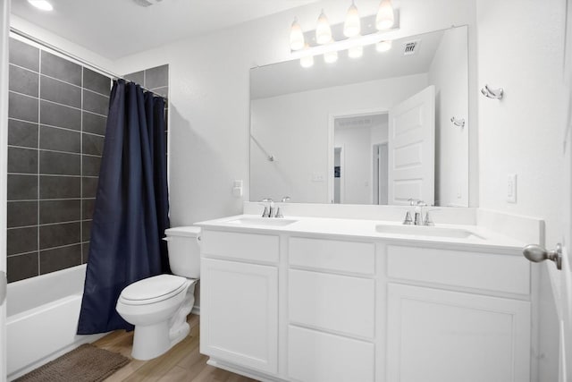 full bathroom with vanity, toilet, shower / tub combo, and hardwood / wood-style floors