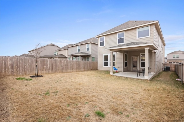 rear view of house with a yard, a patio, and central air condition unit