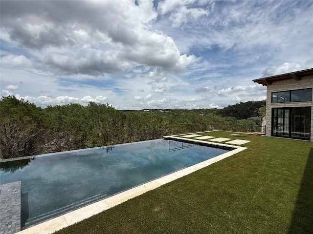 4600 Wild Cow Cv, Spicewood, TX 78669 - view of swimming pool featuring a wooded view