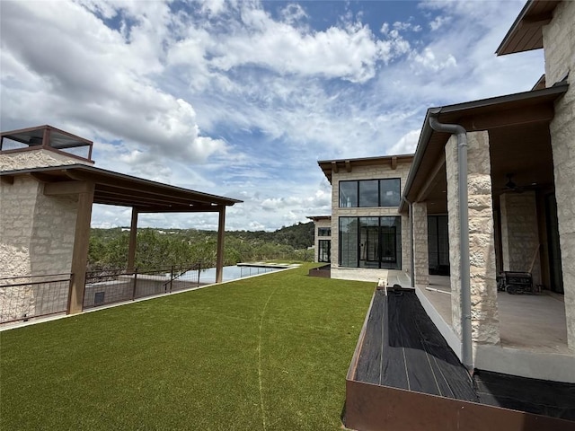 4600 Wild Cow Cv, Spicewood, TX 78669 - view of green lawn with a swimming pool and a patio area