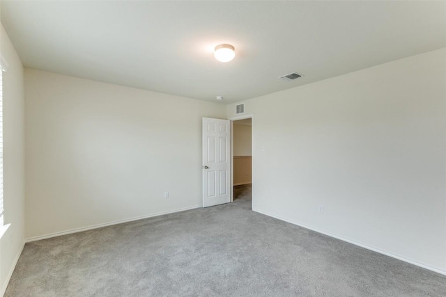 empty room featuring light carpet