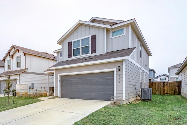 view of front of house with a garage, a front lawn, and central air condition unit