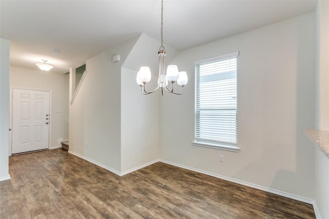 unfurnished room with a chandelier and dark hardwood / wood-style flooring