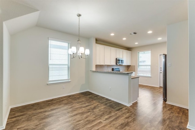 kitchen featuring white cabinetry, dark hardwood / wood-style flooring, kitchen peninsula, and tasteful backsplash