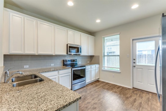 kitchen featuring stainless steel appliances, sink, and white cabinets