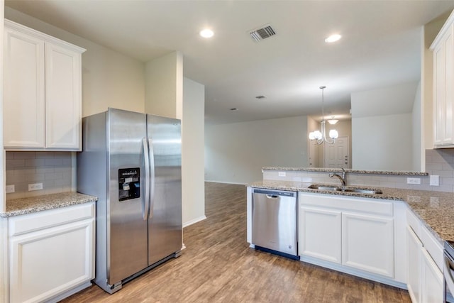 kitchen featuring white cabinetry, appliances with stainless steel finishes, sink, and light wood-type flooring