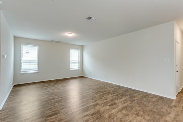 empty room featuring dark wood-type flooring