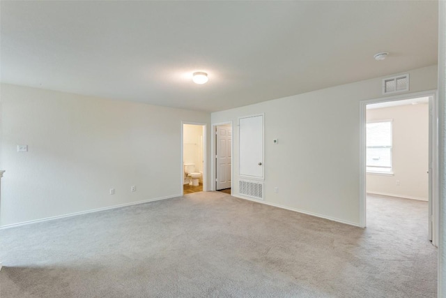 empty room with light colored carpet