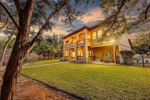 exterior space with a balcony and a yard