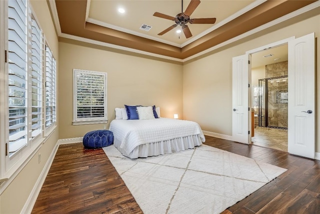 bedroom featuring ceiling fan, ornamental molding, wood-type flooring, and a raised ceiling