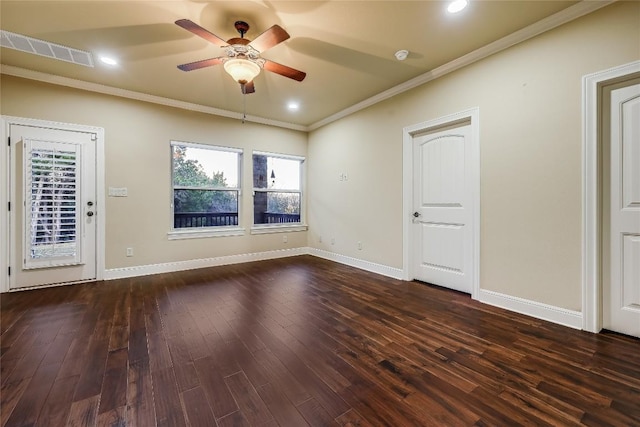 empty room featuring ceiling fan, ornamental molding, and dark hardwood / wood-style flooring