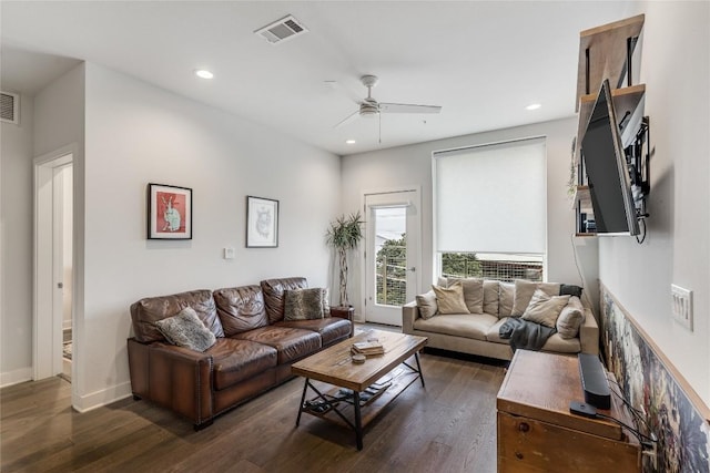 living room featuring ceiling fan and dark hardwood / wood-style floors