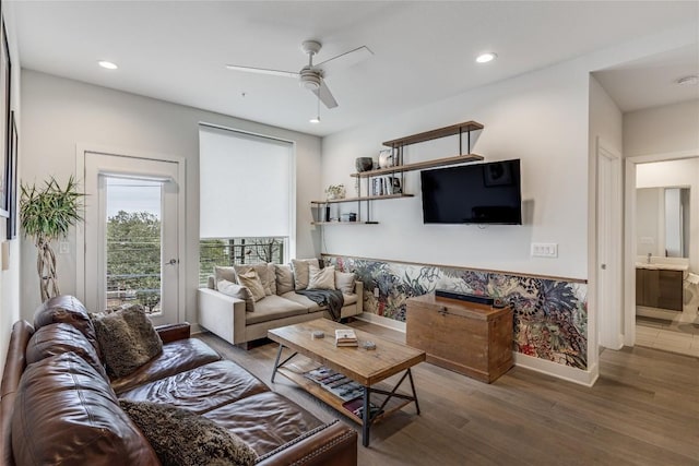 living room featuring ceiling fan and dark hardwood / wood-style floors