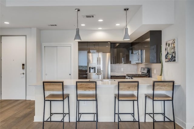 1800 E 4th St Unit 337, Austin, TX 78702 - kitchen with stainless steel appliances, modern cabinets, a peninsula, light countertops, and decorative backsplash