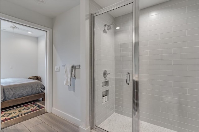 1800 E 4th St Unit 337, Austin, TX 78702 - ensuite bathroom with a stall shower, wood finished floors, baseboards, and recessed lighting